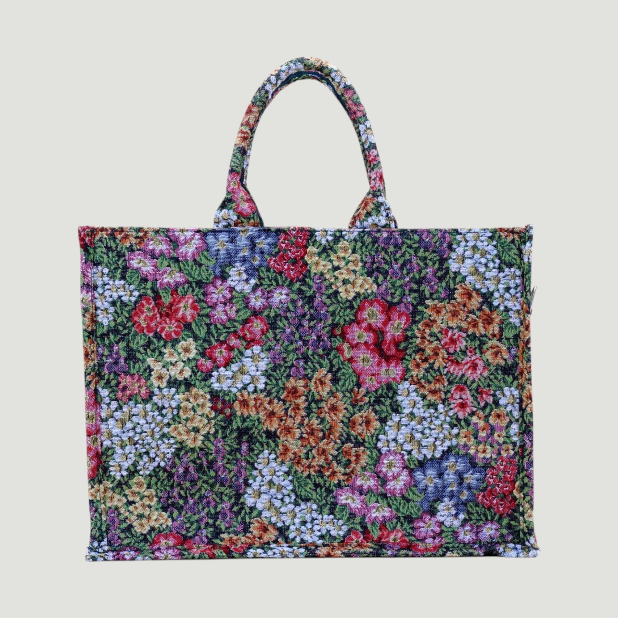 GJEN DESIGN floral tapestry tote bag with multi-colored botanical woven fabric and sturdy top handles.