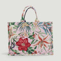 GJEN DESIGN floral tapestry tote bag with a pink background, botanical lily print, and butterfly details.