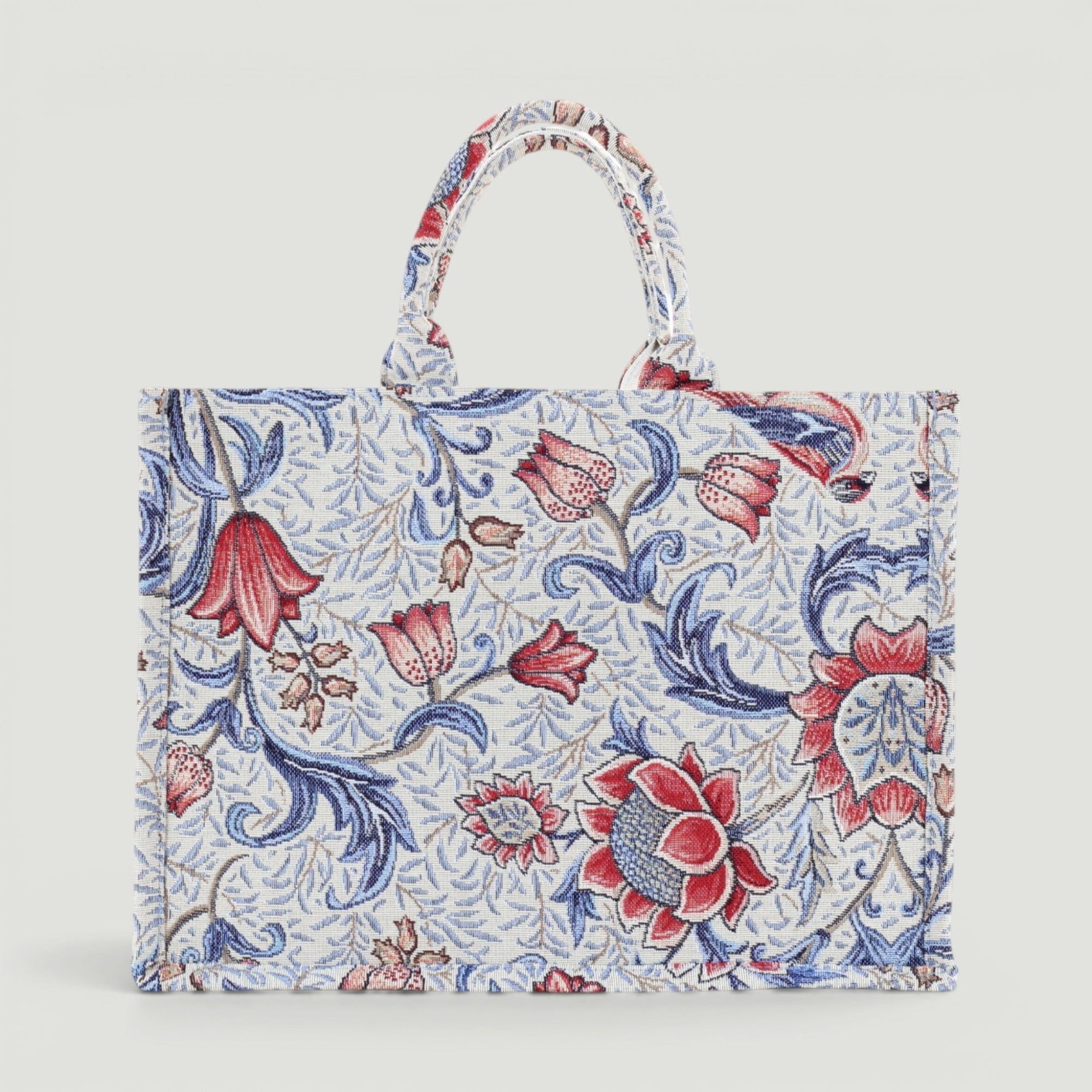 GJEN DESIGN floral tapestry tote bag with red and blue botanical print and sturdy top handles.
