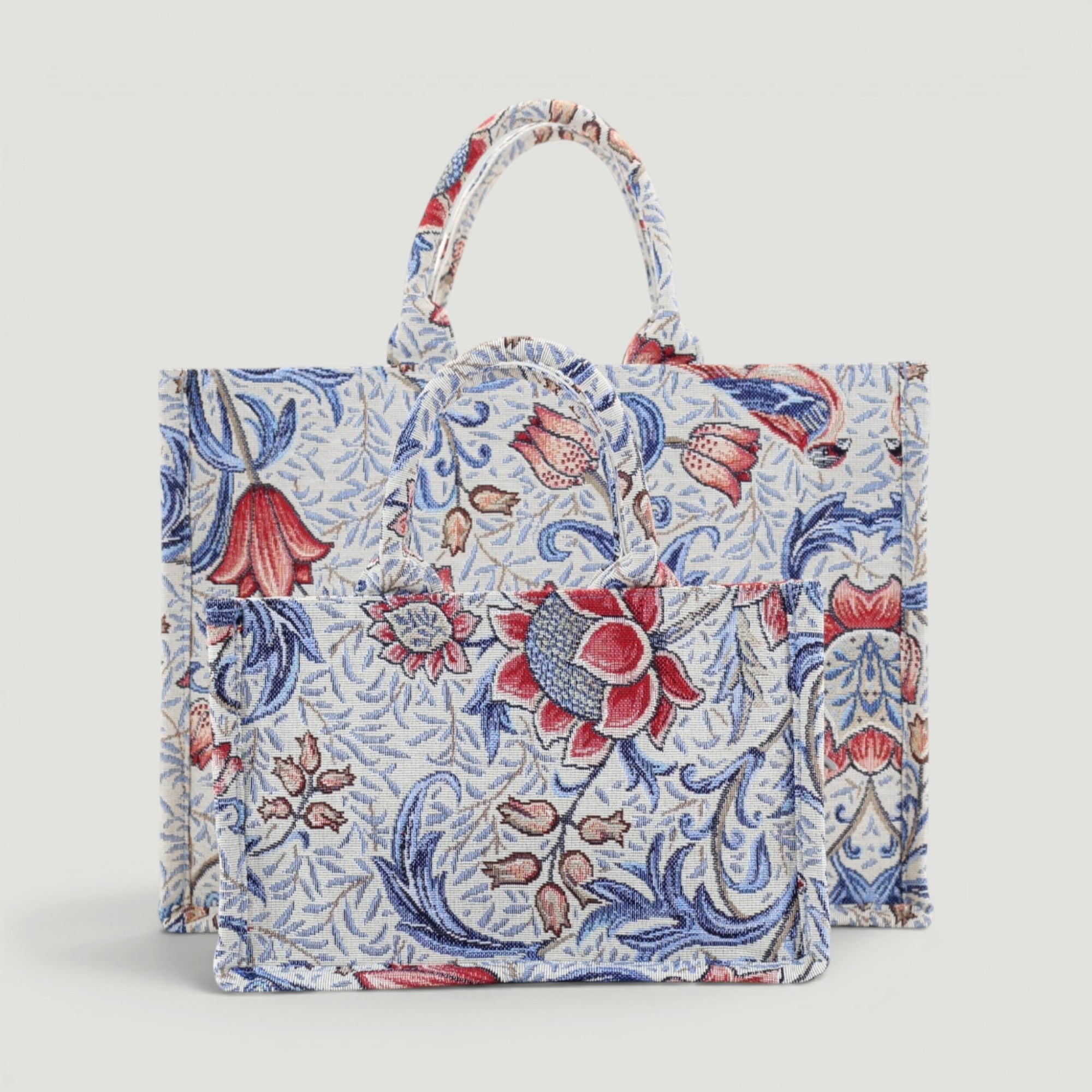 GJEN DESIGN woven floral tote bag in blue and red tapestry fabric with sturdy top handles and structured silhouette.