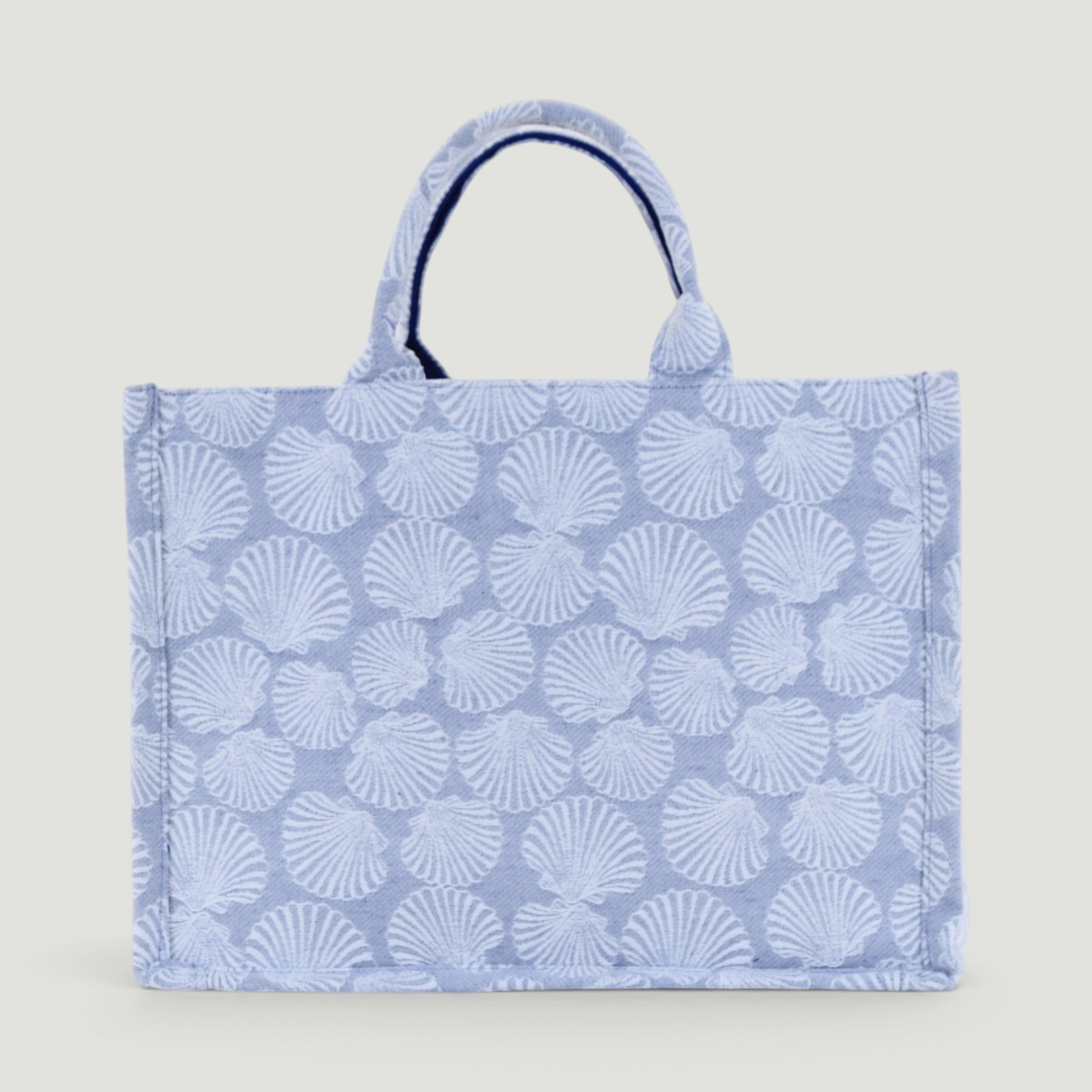GJEN DESIGN structured tote bag in blue and white with an all-over seashell pattern and sturdy top handles.