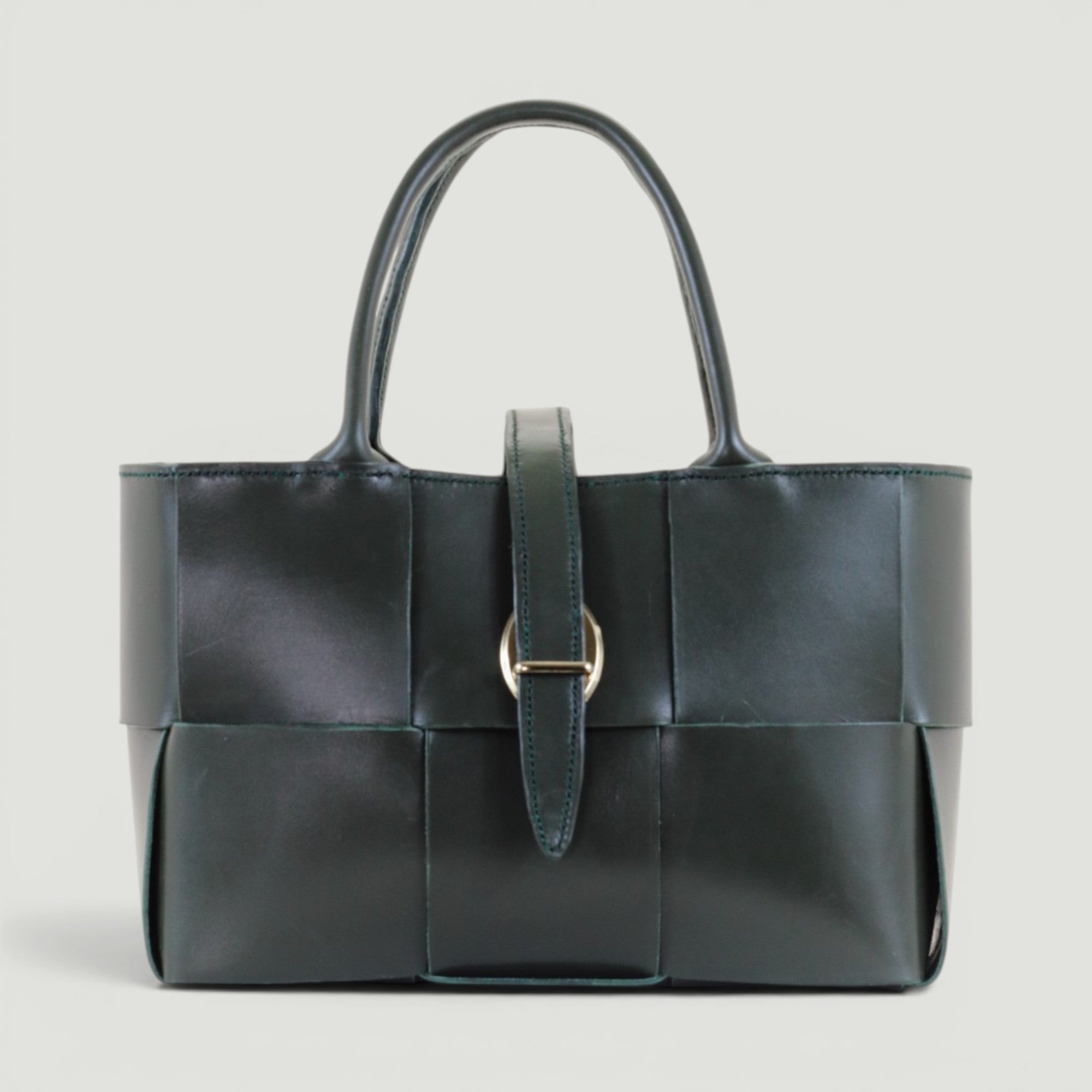 GJEN DESIGN forest green woven leather structured tote handbag with gold-tone buckle closure and top handles.